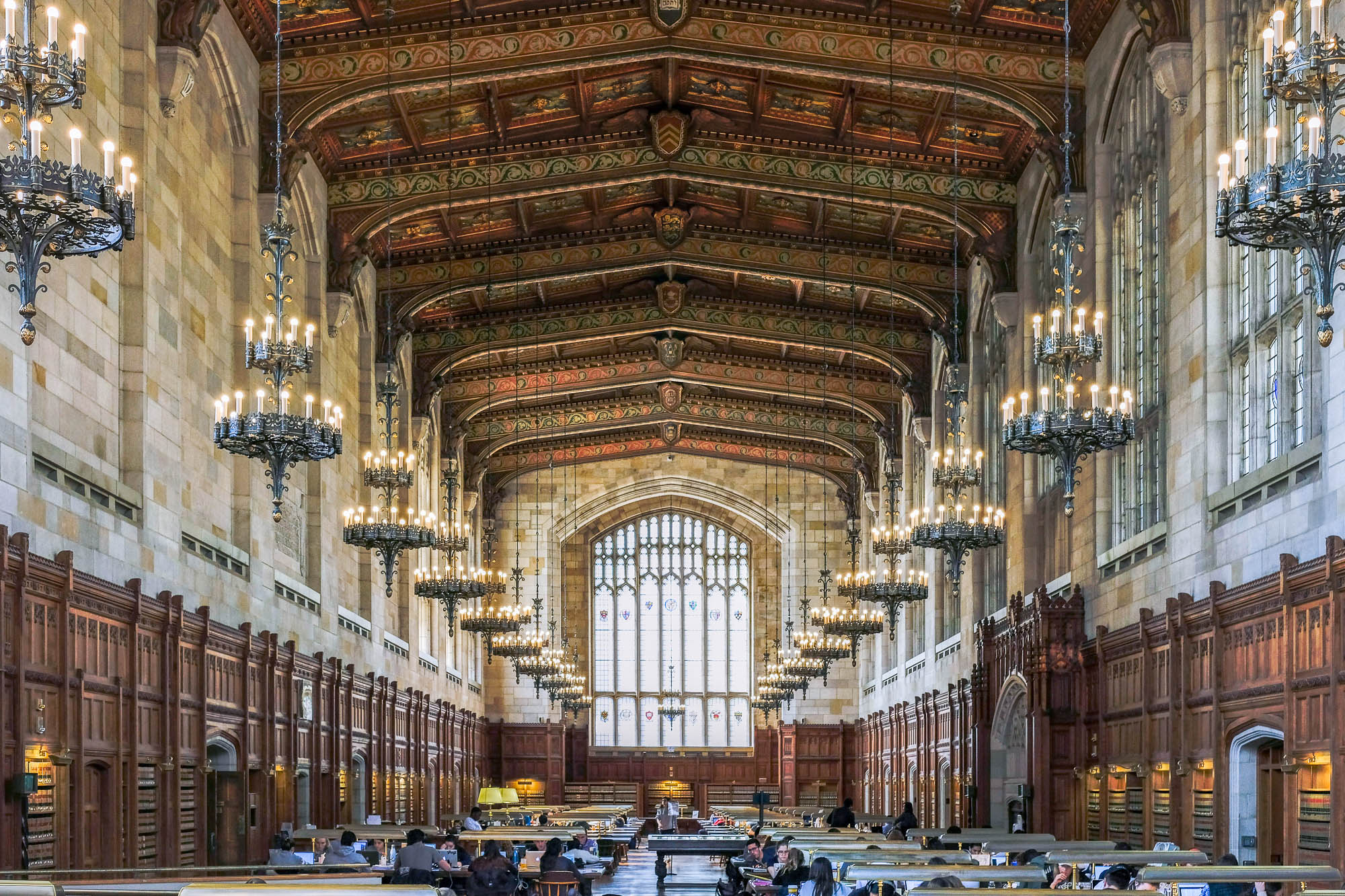 Image of the Cook Library, a neogothic reading room with a decorated ceiling and chandeliers.