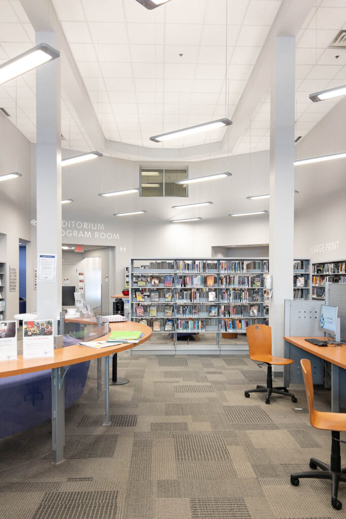 Interior of a contemporary library with grey-white walls.