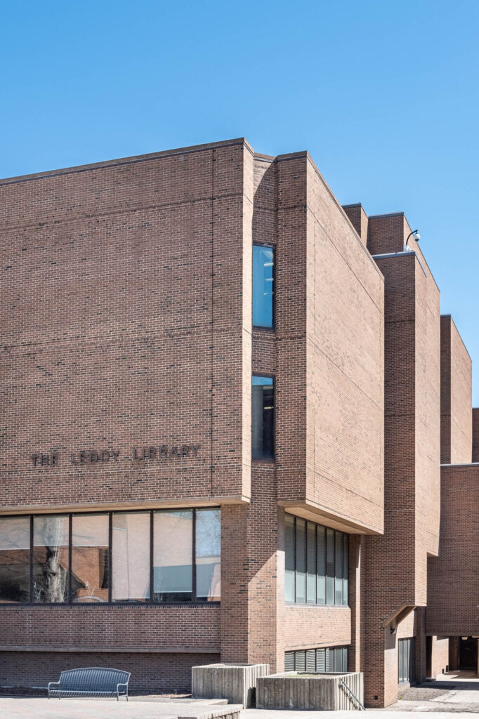 Exterior of a brick modernist library with lettering reading "The Leddy Library"