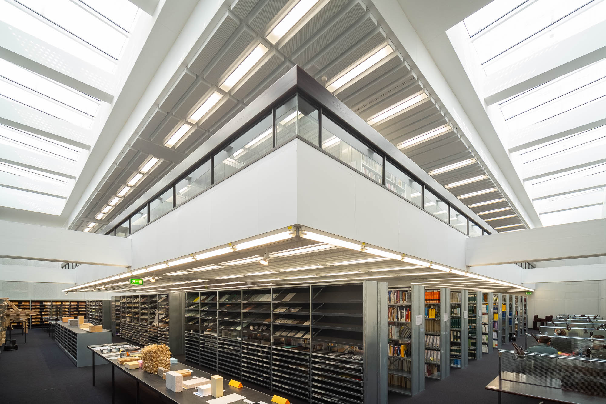 Interior of a modern library with a mezzanine in the centre and light wells illuminating the periphery.