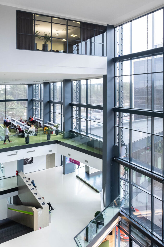 Interior of a contemporary library, a large glass building with angular floors opening to an atrium.
