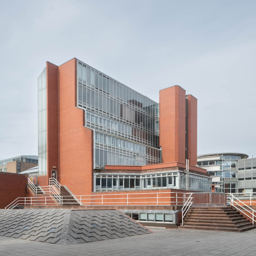 Exterior of a modernist brick and glass library.