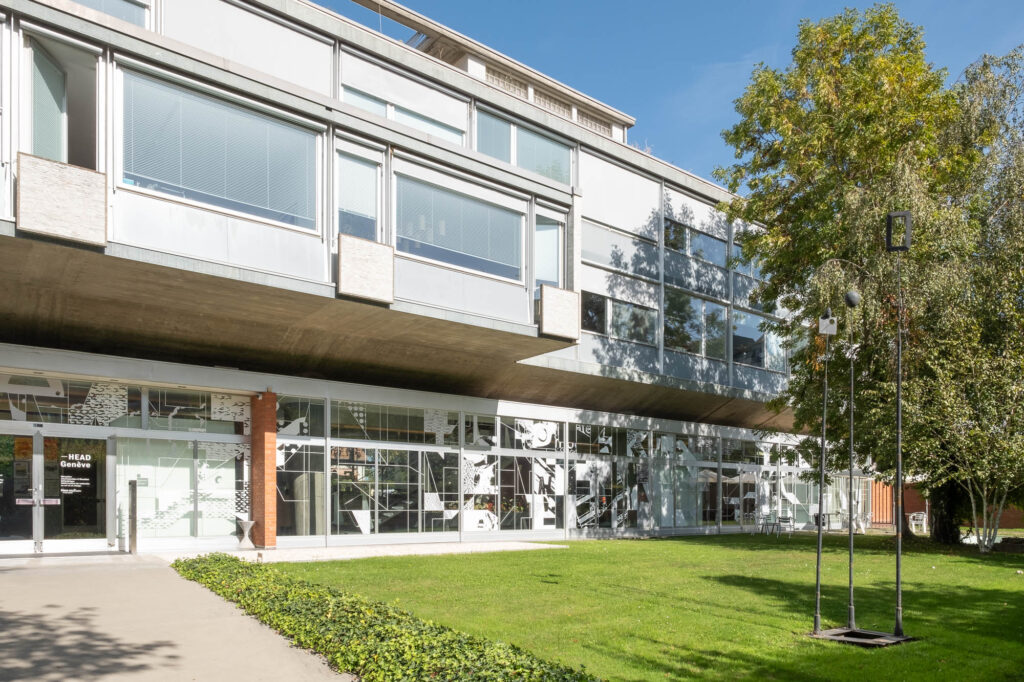 Exterior shot of a Modernist office block, with a park in the foreground.
