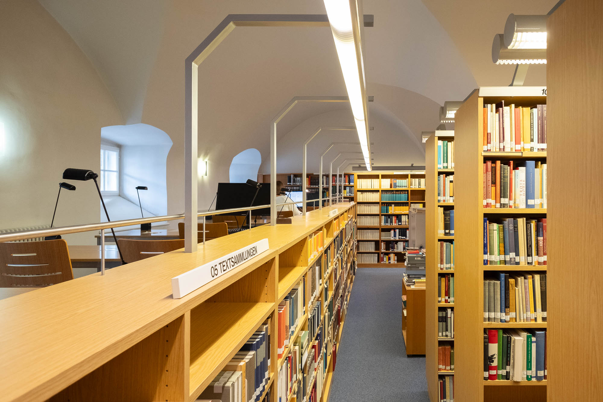 Interior of a library inside a Renaissance palazzo, a vaulted room with timber bookshelves.