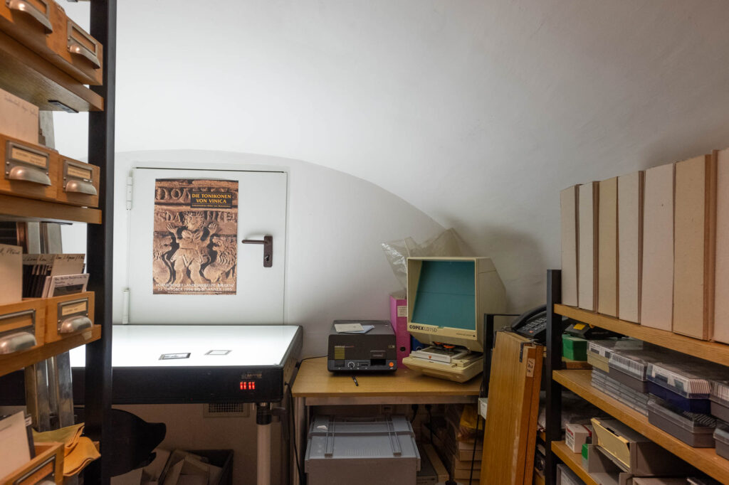 Vaulted room with a light table and microfiche reading equipment.