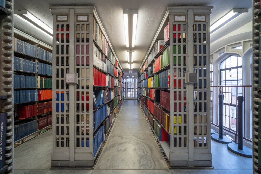 Interior of a book storage block with iron shelves.